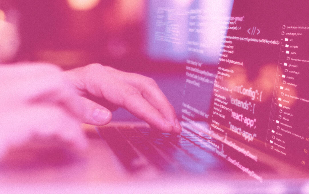 a person's hands on their laptop, doing coding on a website